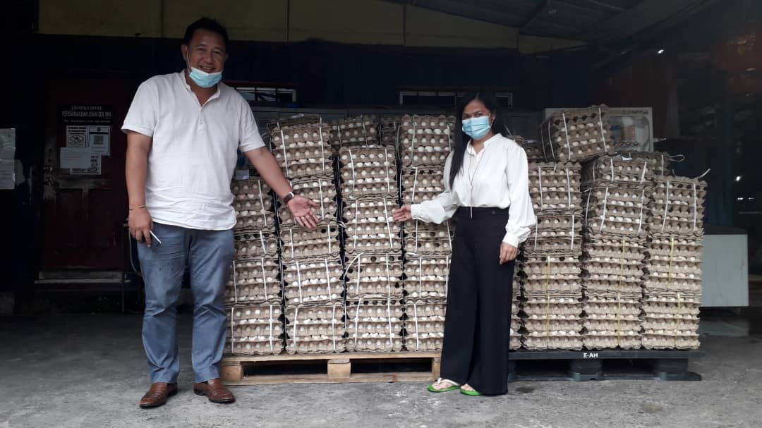 Fadzil (kiri) dan Rosalind menunjukkan 500 tray telur yang akan diagihkan kepada penduduk di lima kampung di Dun Kundasang.